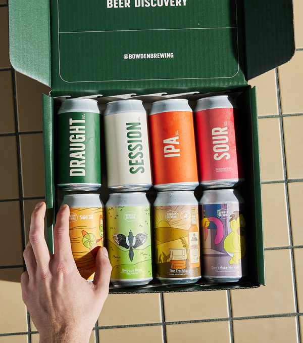8 beers sitting in branded green box